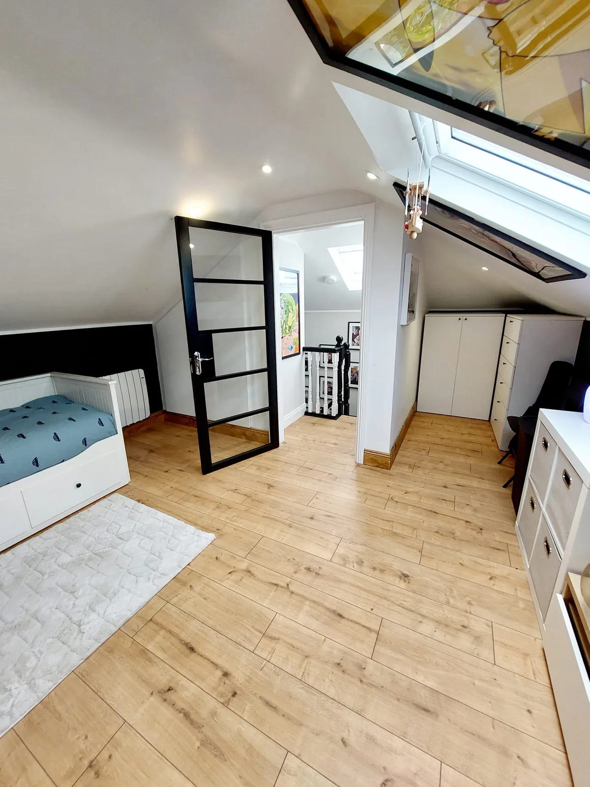 Attic conversion bedroom with apex ceiling and Velux