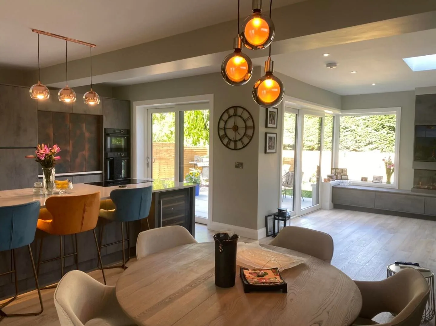 Open-plan kitchen with copper pendants and bifolds