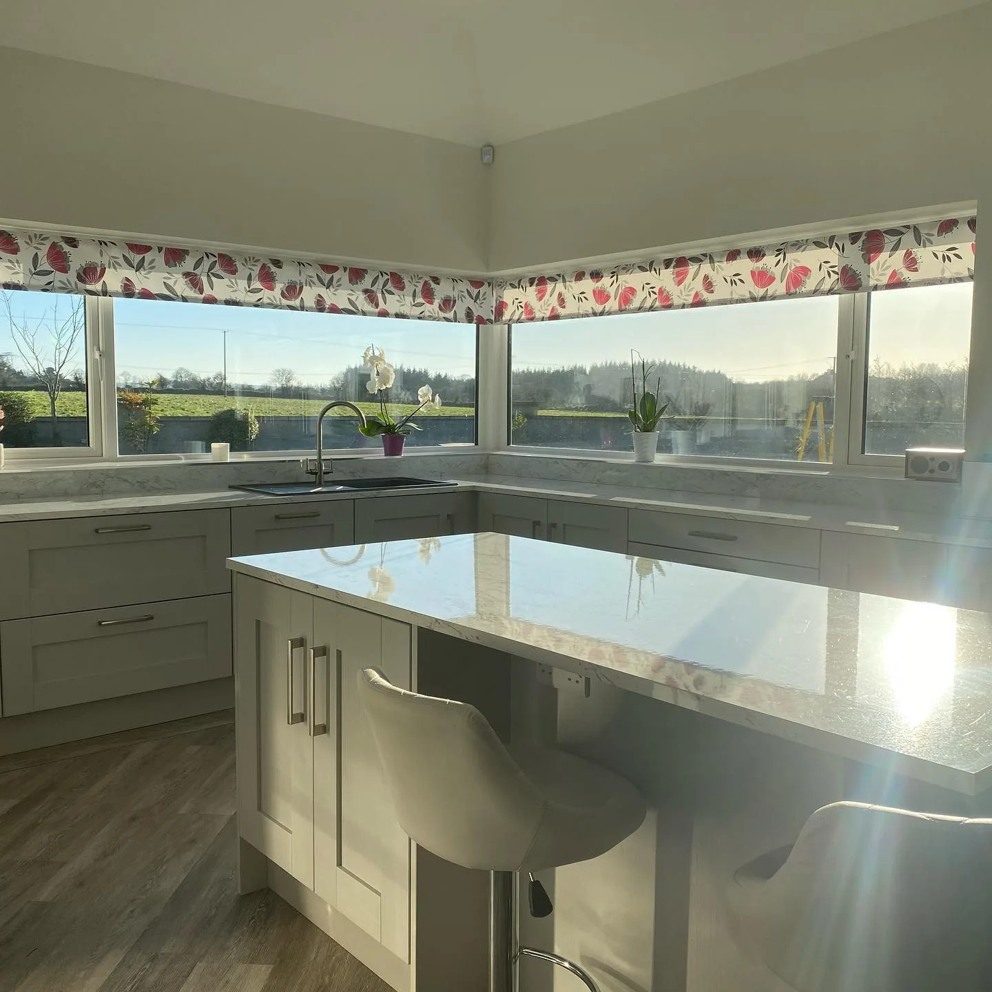 Tri-window kitchen opening onto countryside view